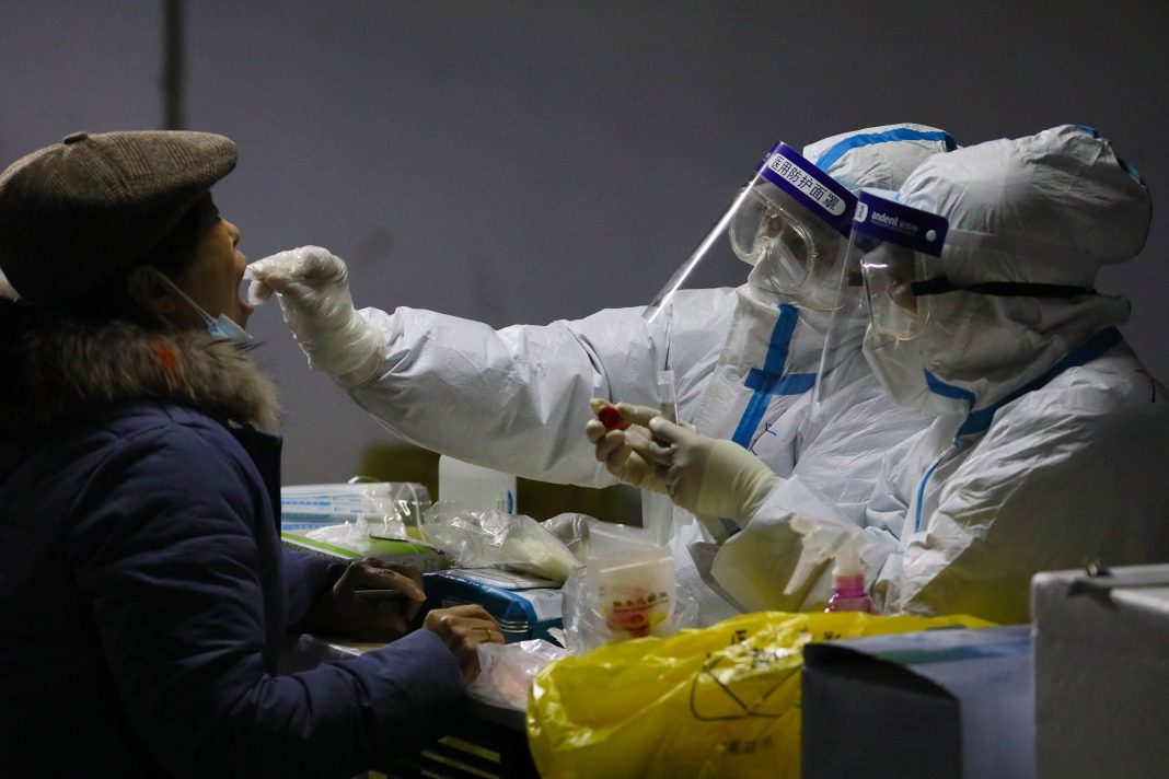 More parts of China lock down as virus cases spike ahead of WHO visit