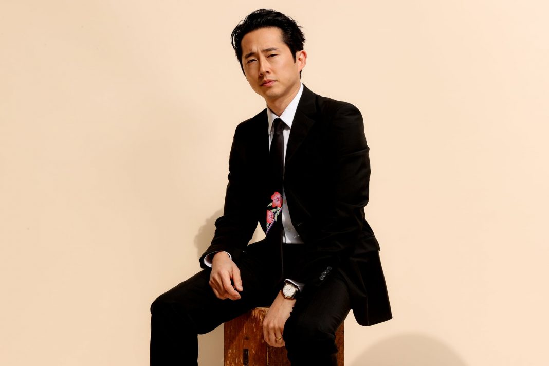 PASADENA, CALIFORNIA - MARCH 7: Steven Yeun wearing PRADA prepares for the 26th annual Critics Choice Awards on March 7, 2021 in Pasadena, California.  (Photo by Rich Fury / Getty Images for PRADA)