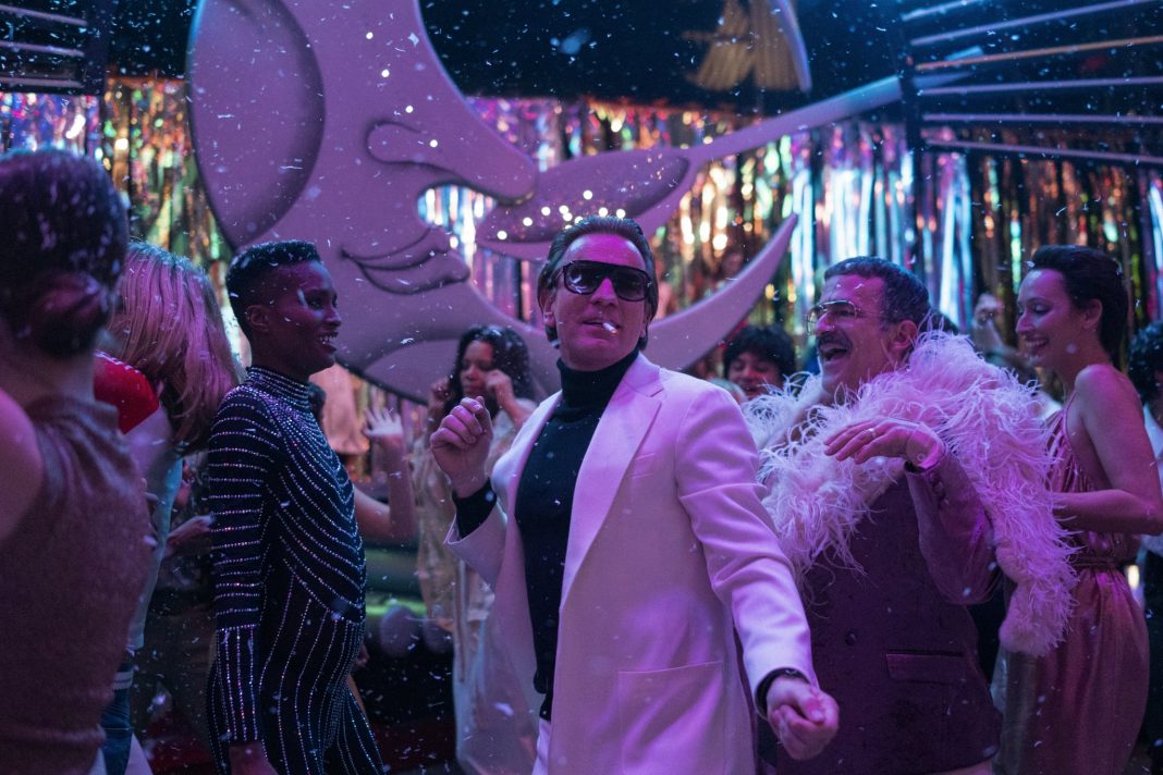 HALSTON (from left to right) EWAN MCGREGOR as HALSTON, DAVID PITTU as JOE EULA and REBECCA DAYAN as ELSA PERETTI in episode 104 of HALSTON Cr.  ATSUSHI NISHIJIMA / NETFLIX 2021
